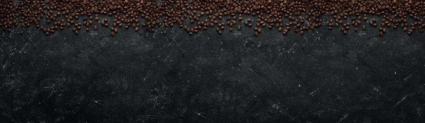Fototapete Cafe Coffee background. Coffee beans on a black stone background. Top view. Free space for your text.  © Yaruniv-Studio
