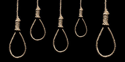 Many hangman's loops on the black background. Creative background, the concept of despair, a dead...