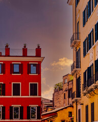 dramatic sunset sky over classic Italian apartment building 