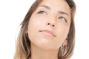 Fototapeta premium A dreamy young woman looking away from the camera