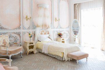 Luxurious expensive interior design of the children's room in the old Baroque style in beige colors