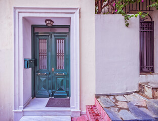 Contemporary house facade with green and black doors, Athens Greece