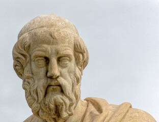 Plato the ancient Greek philosopher statue under dramatic sky, Athens Greece
