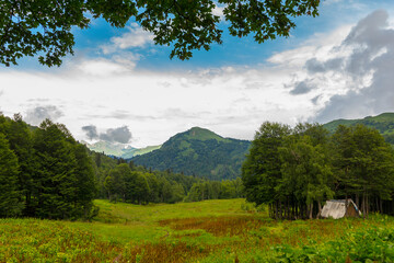 Fototapeta na wymiar Beautiful landscape at Caucasus mountains with small hut
