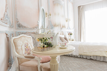 Luxurious expensive interior design of the children's room in the old Baroque style in beige colors
