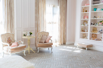 Luxurious expensive interior design of the children's room in the old Baroque style in beige colors