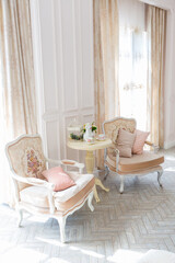 Luxurious expensive interior design of the children's room in the old Baroque style in beige colors