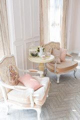Luxurious expensive interior design of the children's room in the old Baroque style in beige colors