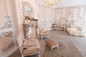 Luxurious expensive interior design of the children's room in the old Baroque style in beige colors