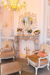 Luxurious expensive interior design of the children's room in the old Baroque style in beige colors