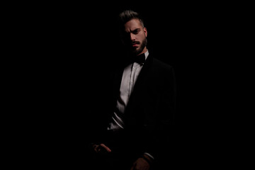 Fototapeta premium sensual businessman in black velvet tux holding hand in pocket