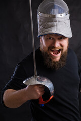 Middle aged bearded man with epee and helmet
