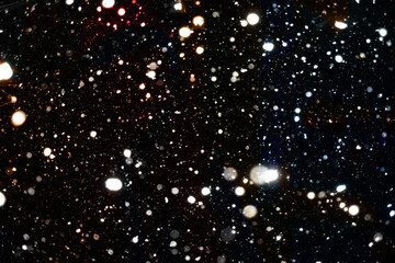 Fototapeta na wymiar Falling snow flakes on black background, useful for overlays