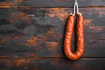 Traditional spanish chorizo sausage on wooden surface with space for text - obrazy, fototapety, plakaty
