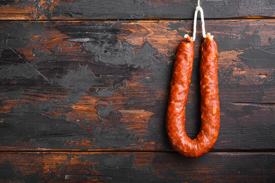 Traditional spanish chorizo sausage on wooden surface with space for text
