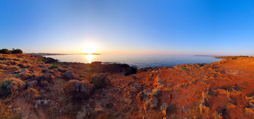 Fototapeta premium Colorful sunset over the water on Crete, Greece.