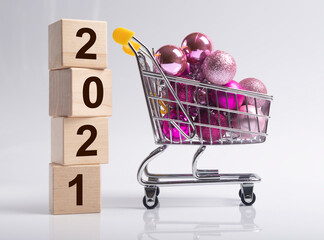 2021 new year with shopping cart or trolley full of miniature christmas baubles or ornaments or...