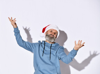 Successful middle-aged man with a beard in a Santa Claus hat rastavit hand to open arms, just the holidays, he was in a blue jacket with a hood on a white background