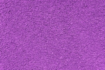 Purple texture. Purple uneven rubber background. The purple rubber playground surface as background.