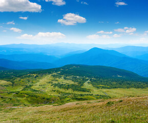 Obraz premium Photo of green meadows and hills at summer day in Carpathian mountains