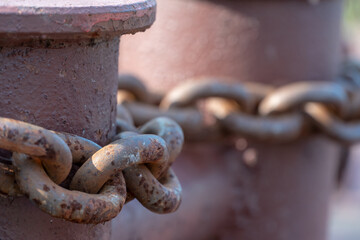 Close-up of bollards and iron chains on an old River barge. Securing the ship with a large chain. Old rusty vintage mooring bollard for boats, ships and yachts. Control system for the ferry.