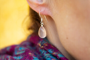 Female ear wearing elegant silver rose quartz gemstone earring