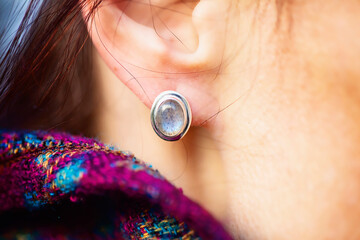 Female ear wearing elegant silver labradorite gemstone earring
