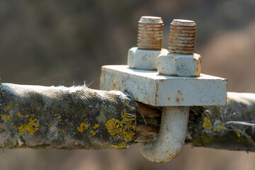 Cables and ropes of the suspension bridge close-up. Repair of the old bridge over the river. Rusty...