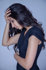 Fototapeta premium Frustrated and depressed woman. Sad tired female person experiencing burnout, pain and loss. Vertical image.