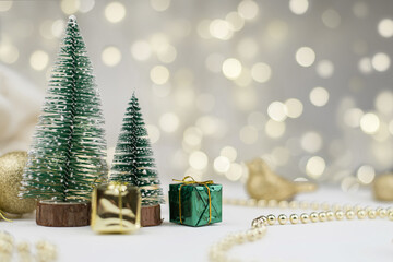 Two decorative Christmas trees and gifts for the new year on the bokeh background, new year mood 2021