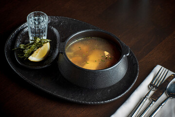 Ukha soup and vodka on table