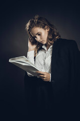 Young beautiful longhaired college girl with papers and jacket on her shoulders