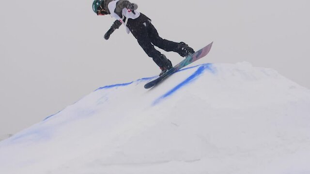 SLOW MOTION: Young pro snowboarder big air