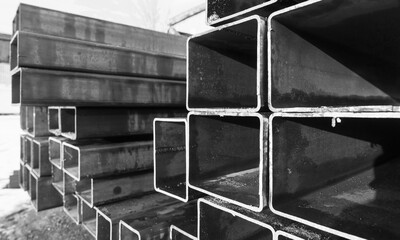 Stack of rolled metal products, black and white