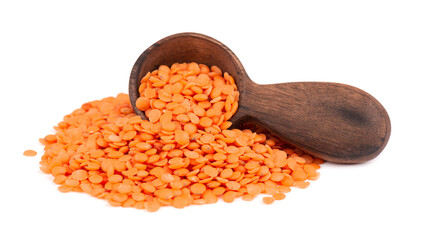 Red lentils in wooden spoon, isolated on white background.