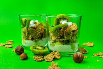 Healthy breakfast. Cereal and yogurt. Close-up on a green background.