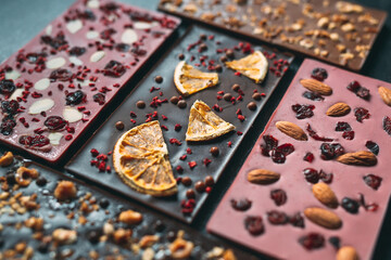 Handmade chocolate bars with a variety of dried fruit and nut toppings.
