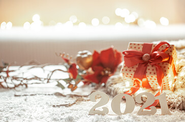 Christmas composition with wooden new years number 2021 and gift box on background.