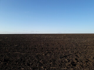 
The field is harvested. Black earth. The field is plowed.