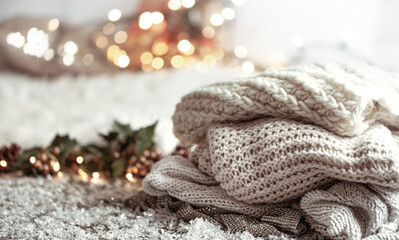 Winter background with knitted elements on a blurred background.
