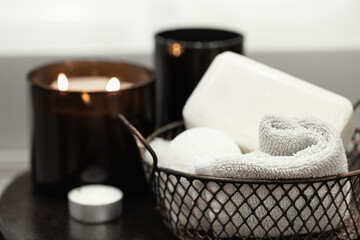 Fototapeta na wymiar Cozy spa composition with bath accessories in a basket close up.