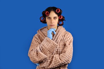 Portrait of a young housewife in a Bathrobe and curlers