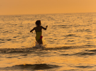girl splashing in sea water