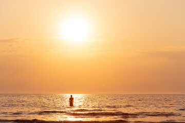 woman on sunset sea beach