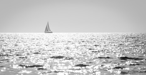 classic seascape with shallow focus on a sailboat