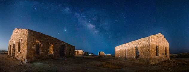 Old village ruins under Milky Way