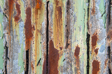 Rust and colours on corrugated iron fence