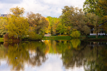 Autumn in the Moscow Victory Park in St. Petersburg, Russia. Trees are reflected in the water