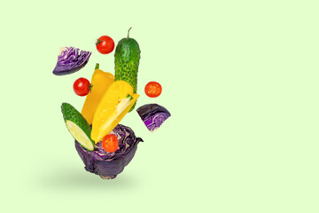 Fresh vegetables, salad ingredients, on a green background.