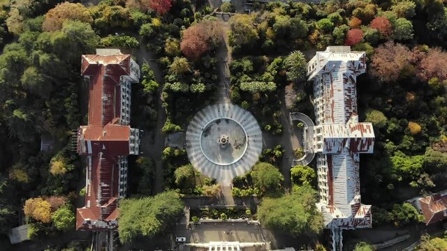 Aerial view of an old abandoned castle in the forest with a large dry fountain. Sochi. Russia.